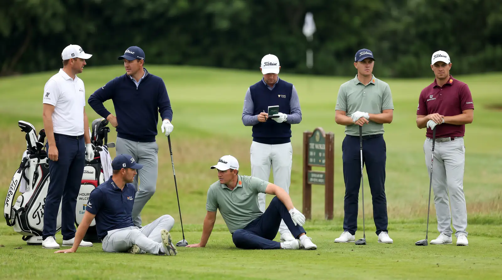 Group of professional golfers gathered on a tee box before play at a UK Tour event