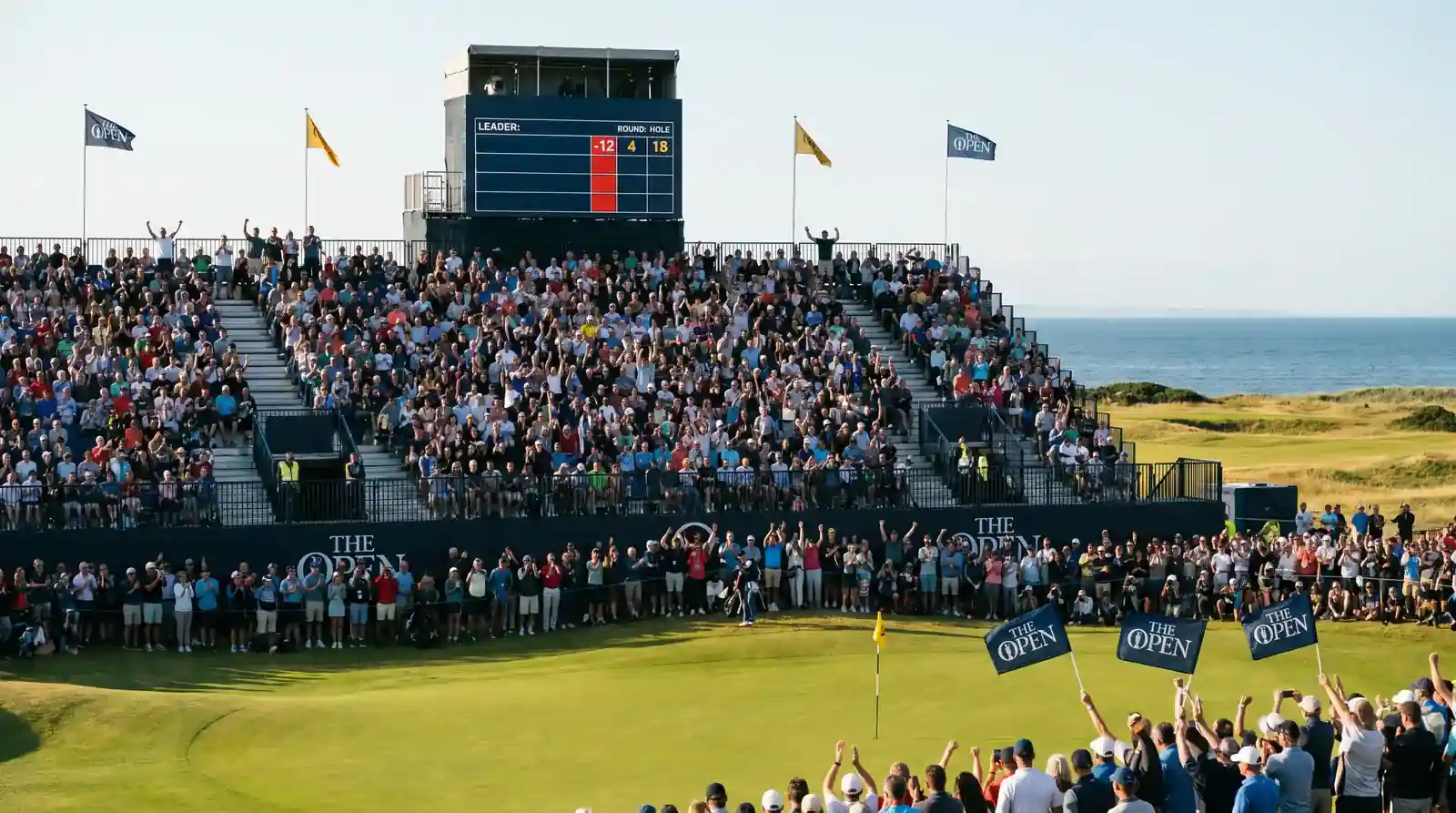 Packed Open Championship grandstand behind the final green during Sunday afternoon with the leaderboard tower clearly visible